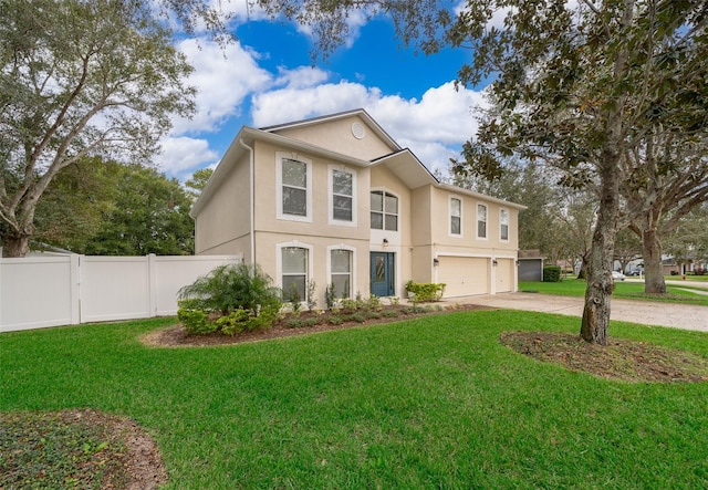 view of front of house with a garage and a front lawn