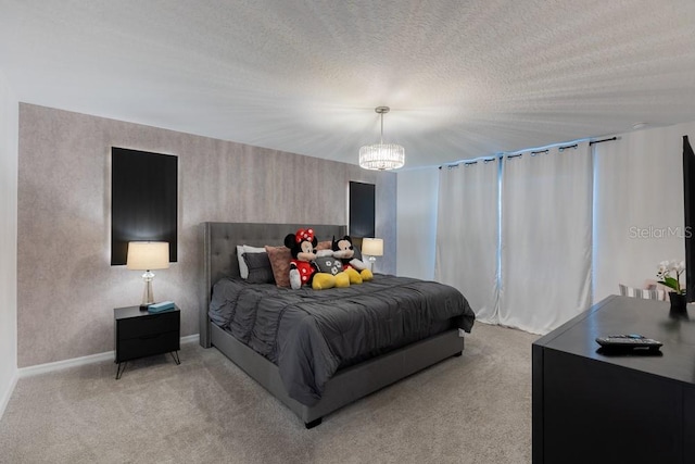 carpeted bedroom featuring a notable chandelier and a textured ceiling