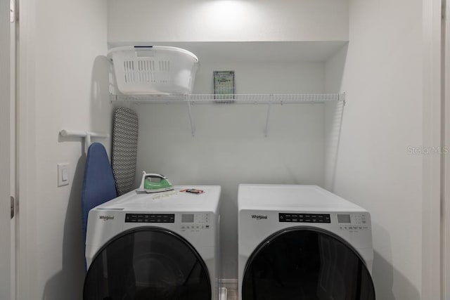 laundry area featuring washing machine and clothes dryer