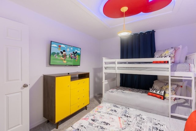 bedroom featuring carpet flooring and a raised ceiling