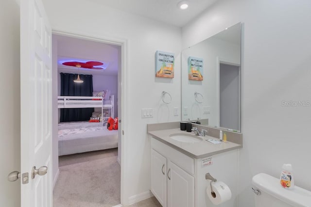 bathroom featuring vanity and toilet