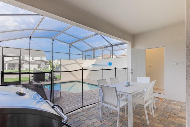 view of swimming pool with glass enclosure and a patio