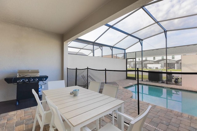 view of pool with area for grilling, a patio area, and a lanai