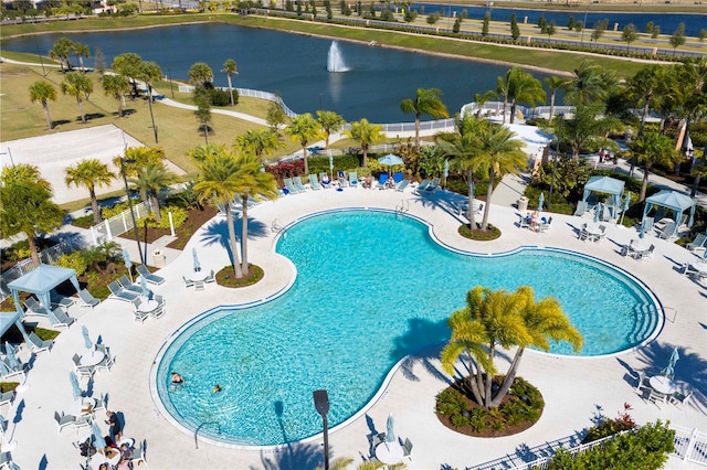 view of swimming pool featuring a water view and a patio area