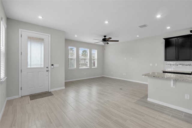 interior space with ceiling fan and light hardwood / wood-style flooring