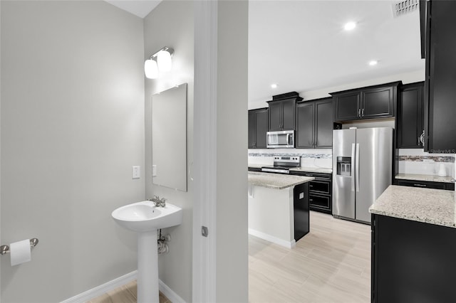 bathroom featuring decorative backsplash and sink