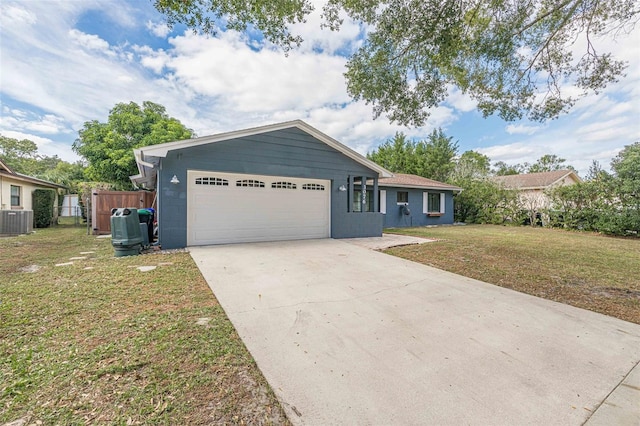 ranch-style home with concrete block siding, driveway, an attached garage, a front lawn, and central air condition unit