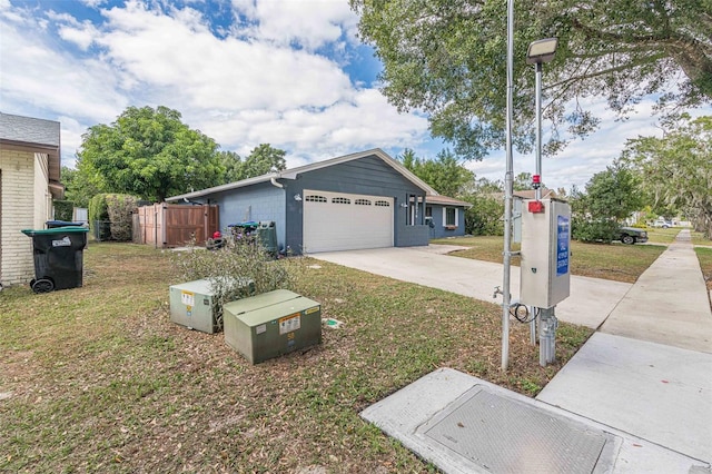 view of front facade with a garage and a front lawn