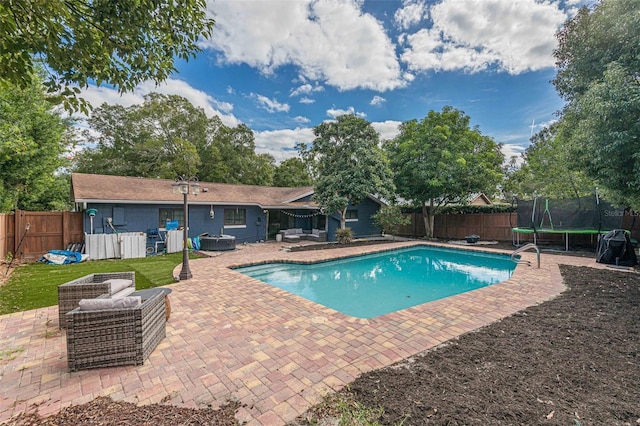 view of pool with a trampoline, a patio area, a fenced in pool, and a fenced backyard