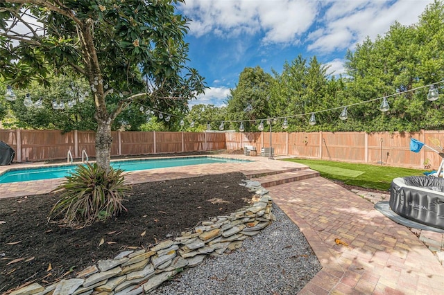 view of pool with a patio area, a fenced in pool, and a fenced backyard