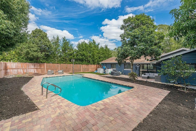 view of pool with an outdoor living space with a fire pit, a patio, a fenced backyard, and a fenced in pool