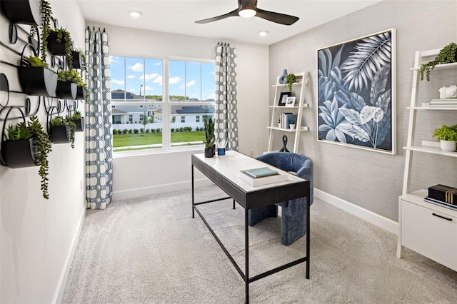 home office with light carpet and ceiling fan