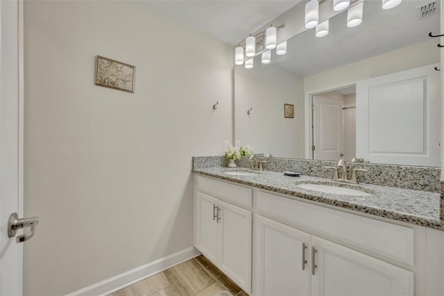 bathroom with vanity and a textured ceiling