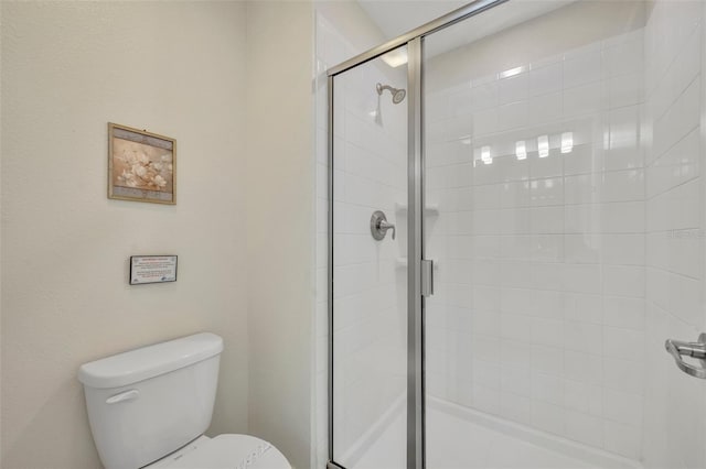 bathroom with an enclosed shower and toilet