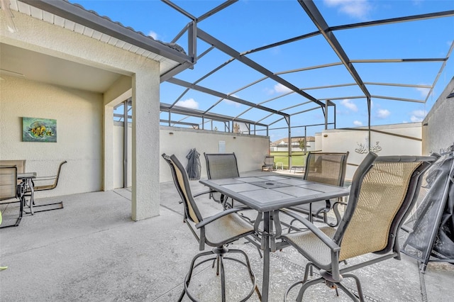 view of patio / terrace featuring a lanai