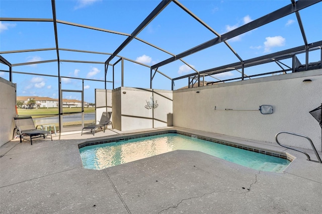 view of swimming pool featuring a patio area and a lanai