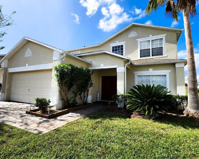 view of front of home with a front yard and a garage