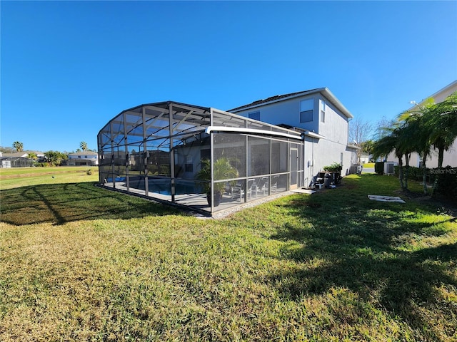 view of yard with glass enclosure