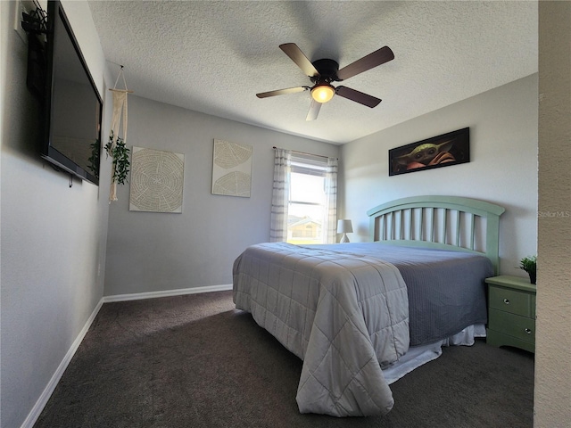 bedroom featuring dark colored carpet, a textured ceiling, and ceiling fan