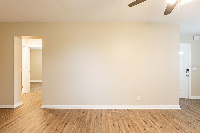 spare room featuring light wood-type flooring and ceiling fan