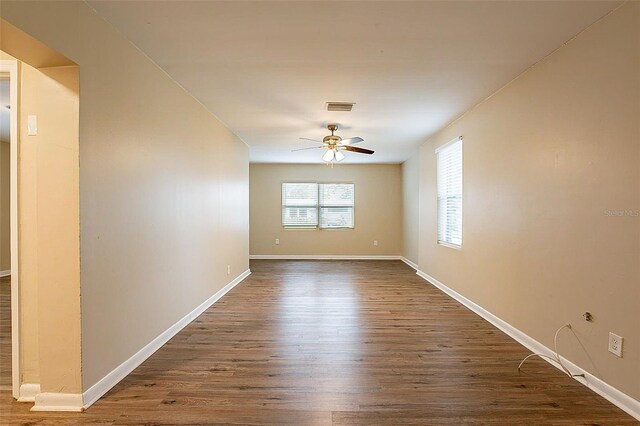 spare room with dark hardwood / wood-style floors and ceiling fan