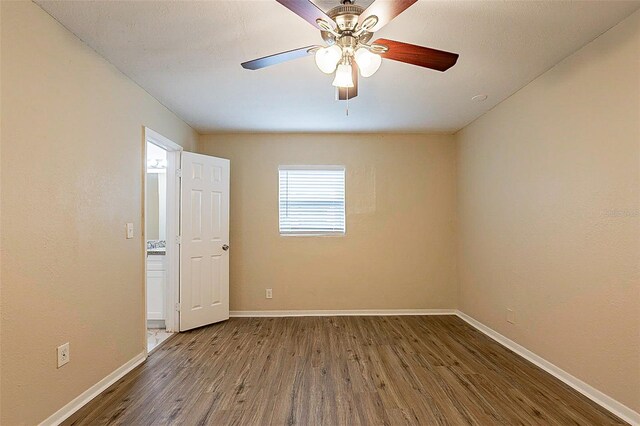 spare room featuring wood-type flooring and ceiling fan