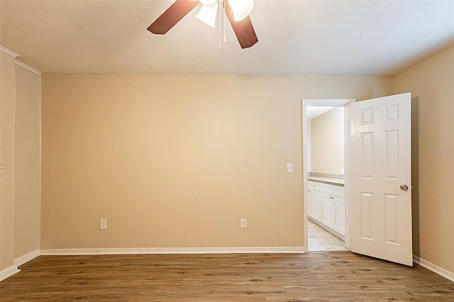 unfurnished room with light wood-type flooring and ceiling fan