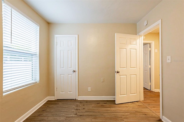 unfurnished bedroom featuring hardwood / wood-style flooring