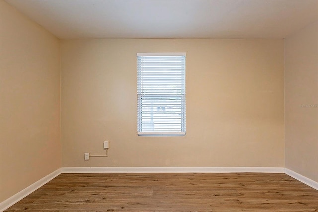 spare room with wood-type flooring