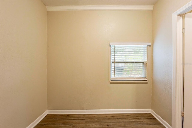 empty room featuring crown molding and hardwood / wood-style floors