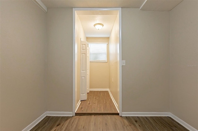 corridor featuring hardwood / wood-style floors