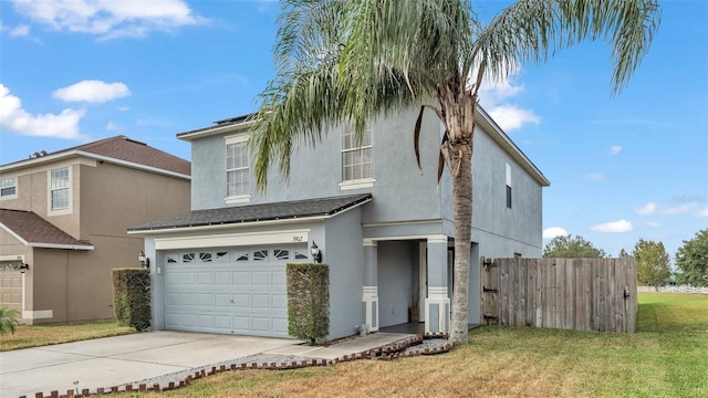 front of property with a front yard and a garage