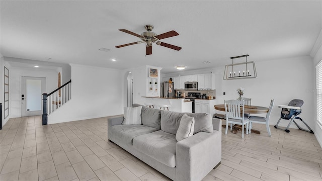 living room with ceiling fan and light wood-type flooring