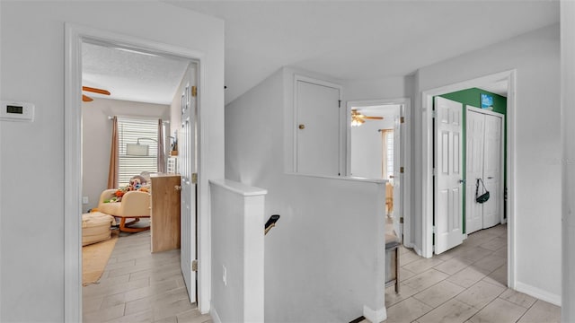 hall featuring a textured ceiling