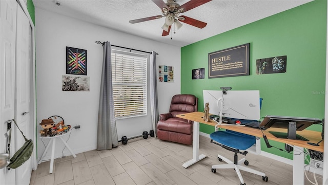 office space featuring ceiling fan, light hardwood / wood-style flooring, and a textured ceiling