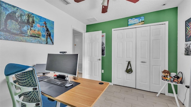 office area with a textured ceiling and light hardwood / wood-style flooring