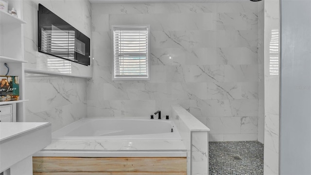 bathroom with vanity and independent shower and bath