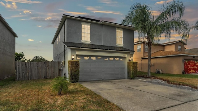 view of front of house featuring a garage and a yard