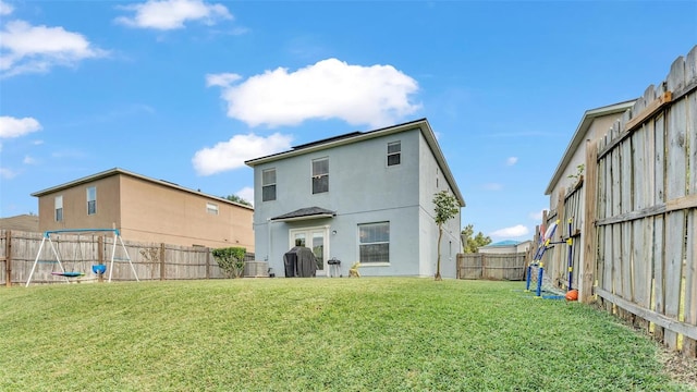 rear view of house with a yard