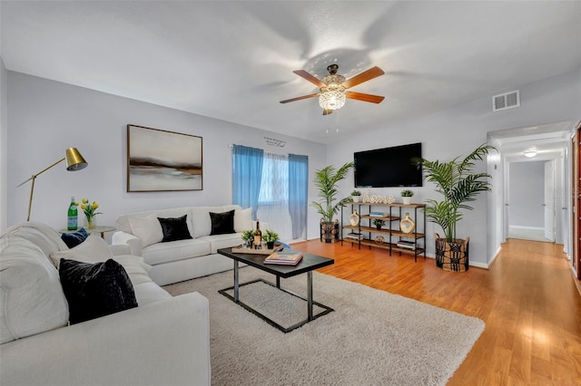 living room with hardwood / wood-style floors and ceiling fan