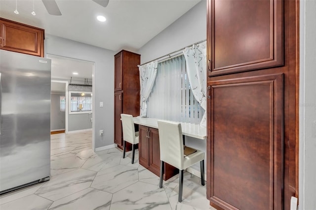 kitchen featuring ceiling fan and stainless steel refrigerator