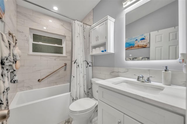 full bathroom featuring shower / tub combo, vanity, toilet, and tile walls