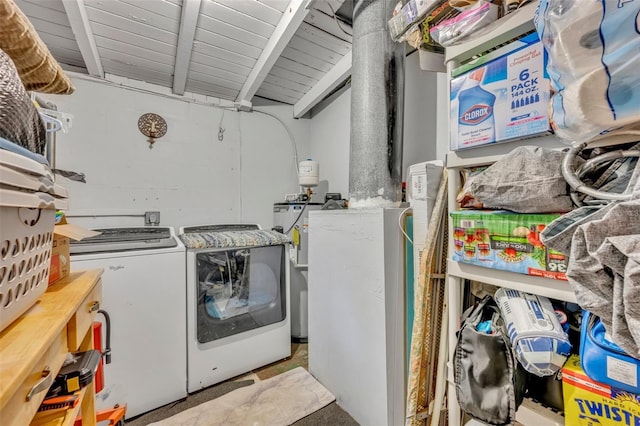 washroom featuring washing machine and dryer and water heater