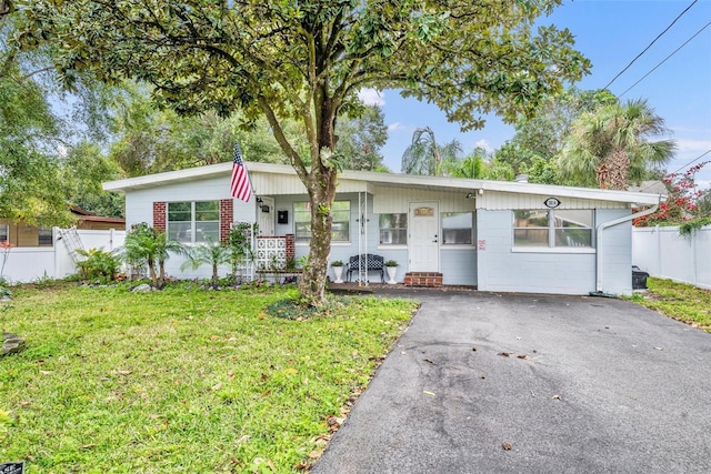 ranch-style house with a porch and a front yard