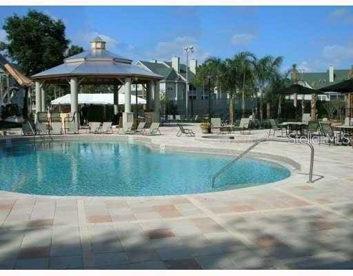 view of swimming pool with a gazebo and a patio area