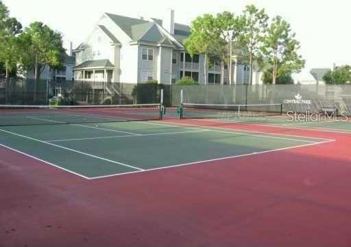 view of tennis court featuring basketball court