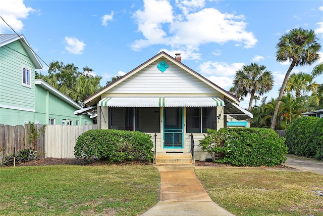 bungalow-style home featuring a front yard