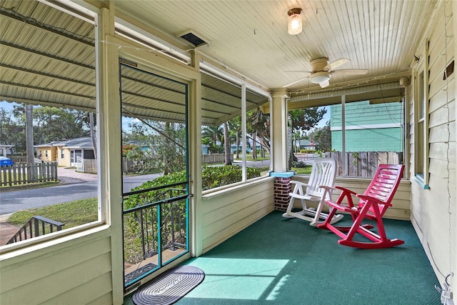 sunroom featuring plenty of natural light and ceiling fan