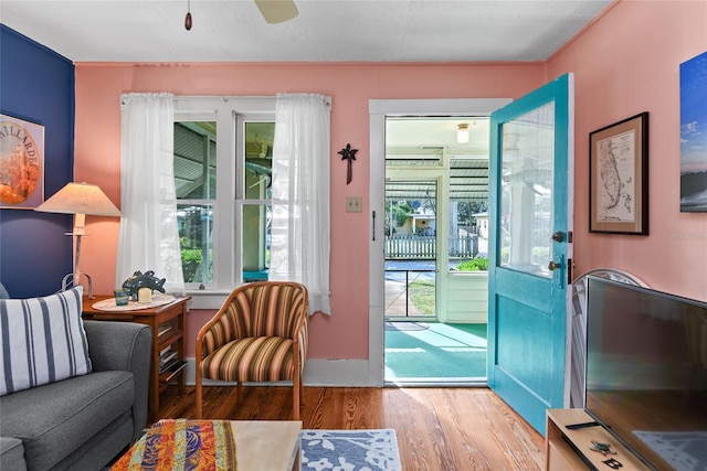 doorway featuring light wood-type flooring and ceiling fan