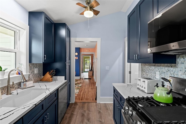 kitchen with sink, stainless steel dishwasher, backsplash, vaulted ceiling, and white range with gas cooktop